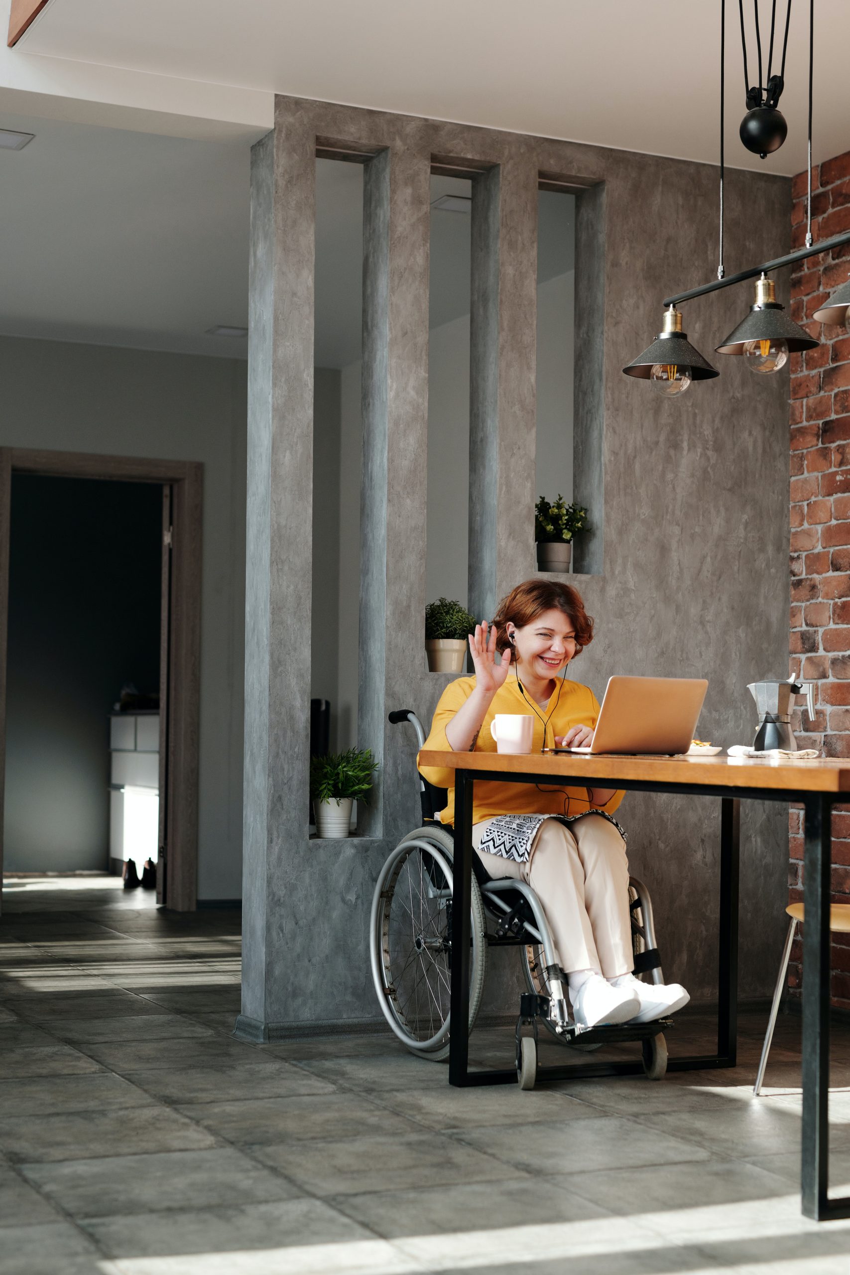 Woman-in-yellow-cardigan-sitting-in-a wheelchair